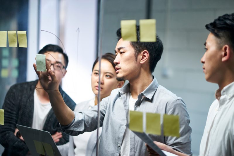 Young,Asian,Entrepreneur,Of,Small,Company,Putting,A,Adhesive,Note
