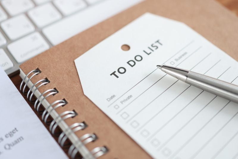 Paper,With,Inscription,To,Do,List,Lying,On,Notebook,Closeup.